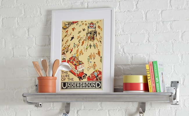 Poster in a white frame sitting atop recommissioned luggage rack