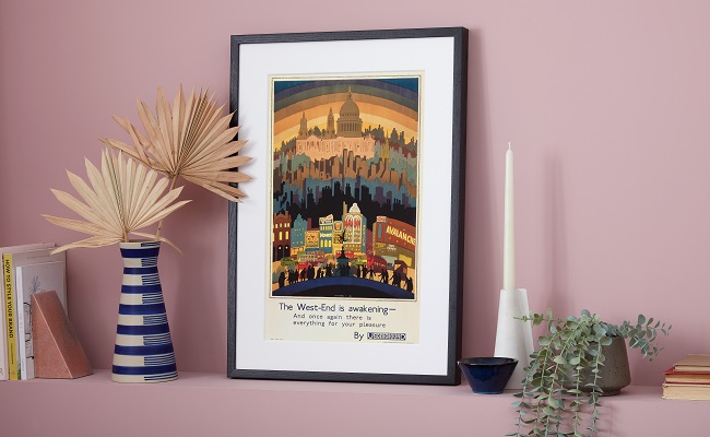 Framed West End is awakening print leaning against pale purple wall